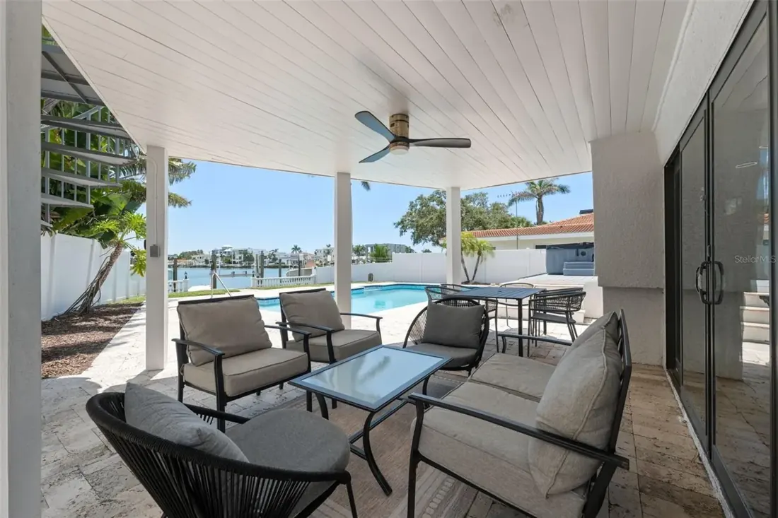 Covered outdoor living space overlooking the pool